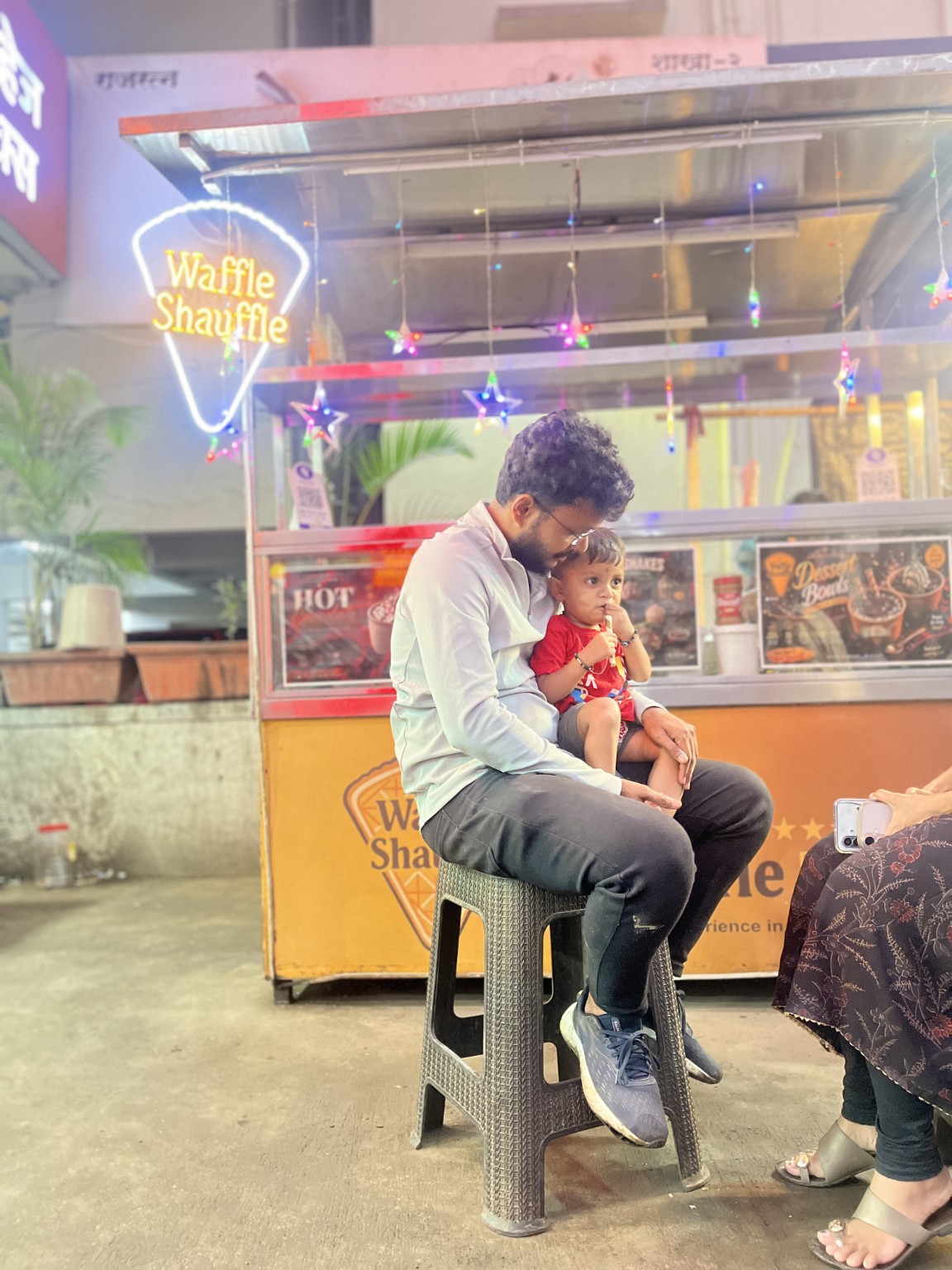 Family moment with a parent and child at Waffle Shauffle in Bhekrai Nagar, Pune
